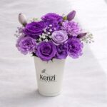 purple flowers in a coffee cup