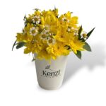 yellow flowers in a coffee cup